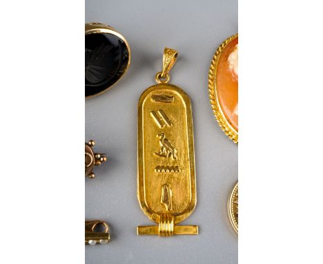 An Egyptian gold oval pendant, cast with hieroglyphics, approx 3.5g; a yellow gold and seed pearl bar brooch, unmarked, appro