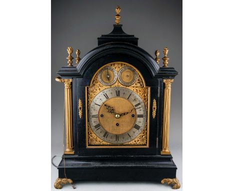 A late Victorian ebony cased triple fusee table clock, circa 1880, the silvered chapter ring with Roman and Arabic numerals, 