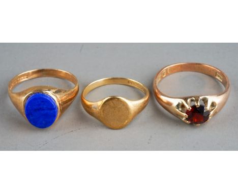 Three 9ct yellow gold rings, one set with a garnet size Q; one set with lapis lazuli, size O and a plain signet ring, size K,