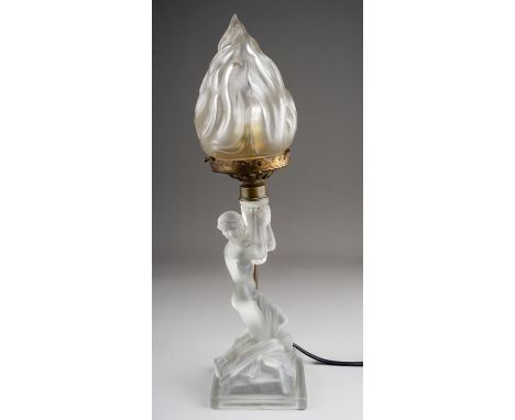 An Art Deco frosted glass table lamp, the base moulded as a kneeling scantily clad female holding aloft a flame shade, height
