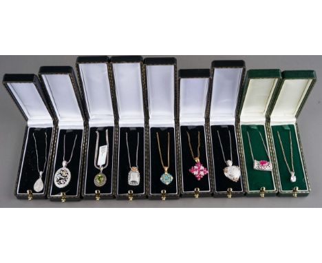 A collection of silver gem-set pendant necklaces, including peridot and marcasite, ruby, CZ etc (9) 