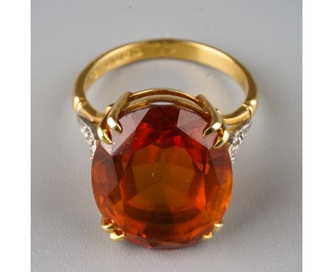 An 18ct yellow gold citrine and diamond dress ring, set with an oval cut citrine in claw settings, diamond set shoulders, siz