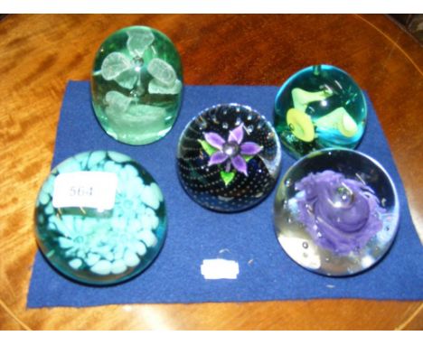 A Caithness flower paperweight, together with four others