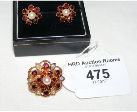 A suite of jewellery comprising clip brooch and earrings in garnet and pearl