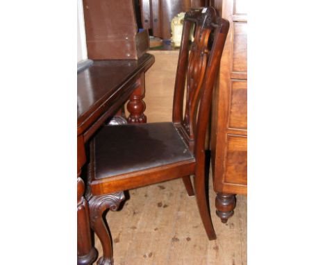 A set of four Chippendale style mahogany dining chairs with carved cabriole front supports
