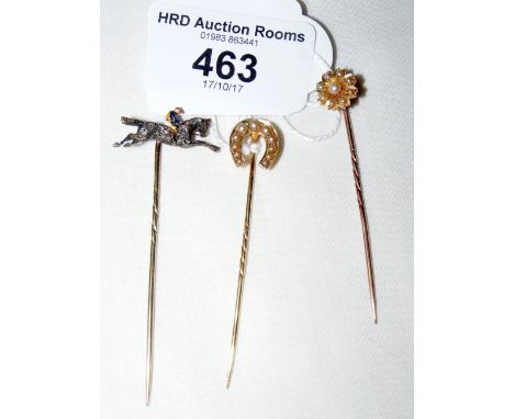 Two seed pearl mounted gold stickpins and a diamond mounted jockey on horseback ditto