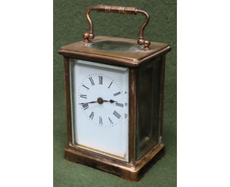 20th century French style brass and glass mantle clock with enamelled dial. Approx. 15cm H including carry handle.
Reasonable