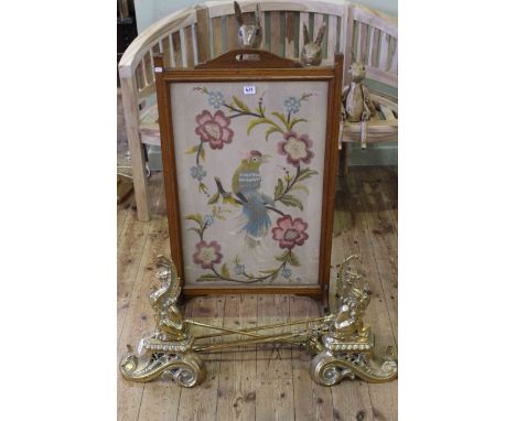 Pair brass dragon fire dogs, three brass fire irons and oak framed needlework panel firescreen