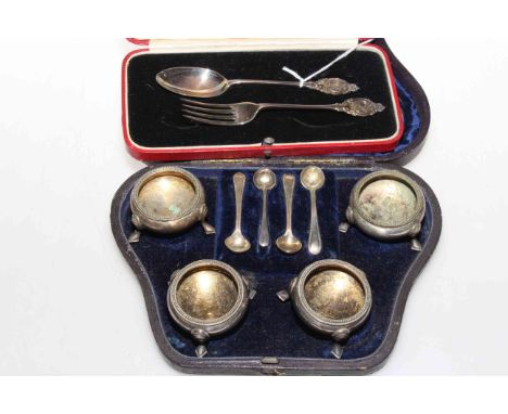 Cased silver fork and spoon; and a cased set of four plated salts with spoons