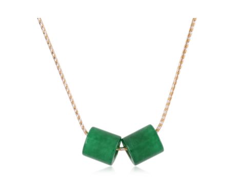 A PAIR OF JADE 'BARRELS' ON A HIGH KARAT TWO TONE GOLD CHAIN
Featuring a pair of jade 'barrels', accompanied with a high kara
