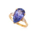 A TANZANITE AND DIAMOND THREE STONE RING.