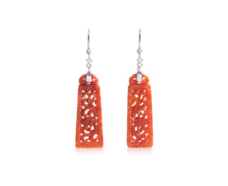 A PAIR OF JADE EARRINGS
Featuring a pair of carved jade mounted to a white gold setting marked '14K', accented with two white