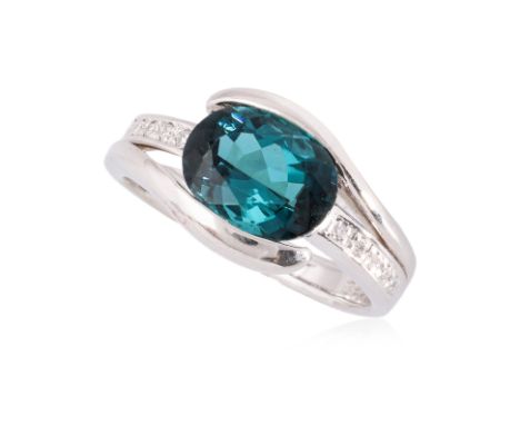 A TOURMALINE AND DIAMOND RING
Featuring a greenish blue oval cut tourmaline weighing approximately 2.62 Cts (marked), mounted