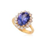 A TANZANITE AND DIAMOND 'HALO' RING
