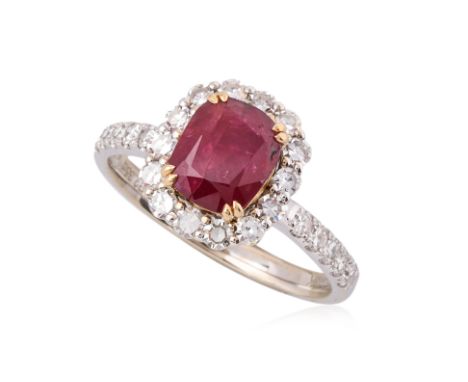 AN UNHEATED RUBY AND DIAMOND HALO RING
Featuring a unheated cushion cut ruby weighing approximately 2.35 Cts (marked), mounte