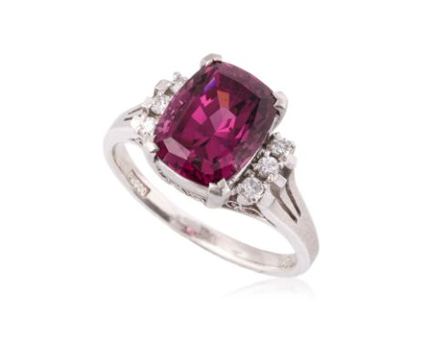 A RHODOLITE GARNET AND DIAMOND RING
Featuring a cushion cut rhodolite garnet weighing approximately 4.29 Cts (marked), mounte