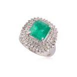 AN EMERALD AND DIAMOND 'TRIPLE HALO' RING