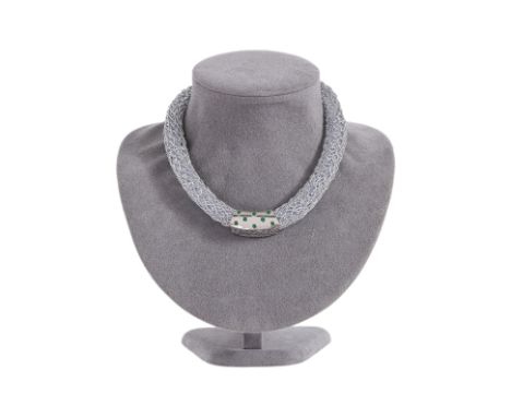 TWO SIMILAR JADE PENDANTS WITH A SPRINGY NECKLACE
Featuring jade pieces mounted in white gold settings, one marked '750' for 