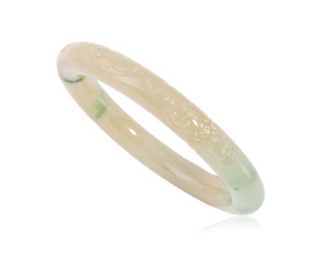 A CARVED TYPE A JADEITE BANGLE Featuring a Type A jadeite bangle with carved flowers, weighing approximately 303.50 Cts. Acco