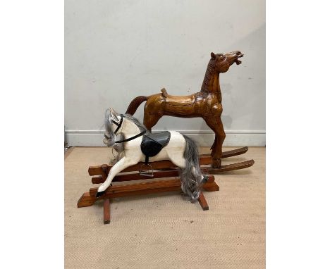 A wooden rocking horse, with carved decoration, height 110cm, with a smaller painted example, height 76cm (2)