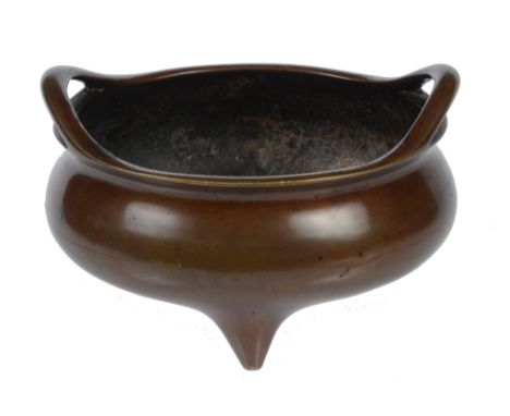  A bronze tripod censer  , of compressed form with outswept pierced handles, Xuande six-character mark to the base, 11.5 cm d