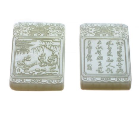  Two white jade plaques  , of rectangular shape, carved on one side in low relief with a panel depicting prunus branches, the
