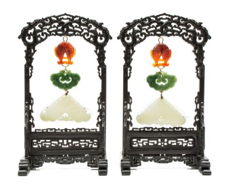  A pair of white jade chimes, 19th century  , each finely carved with figures amid a garden setting, within swirling, ruyi cl