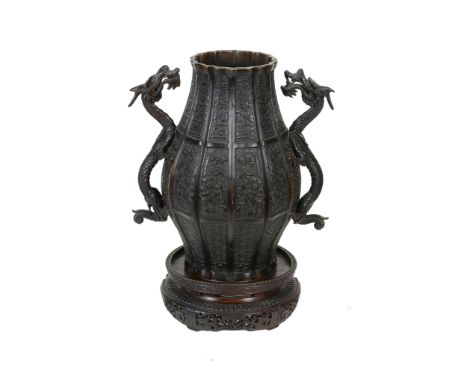  A Japanese Bronze Vase   of panelled bulbous form decorated with archaistic motifs on a key-fret diaper ground, the sides mo