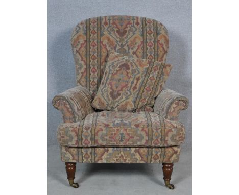 A 19th century style armchair in tapestry upholstery on turned tapering supports. H.100 W.83 D.70cm 