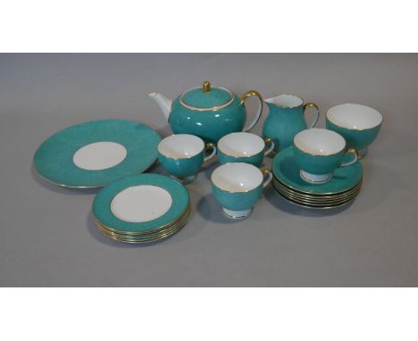 A part six person Wedgwood tea service. The set has a dappled turquoise and gilt design. Makers stamp to the base. (two tea c