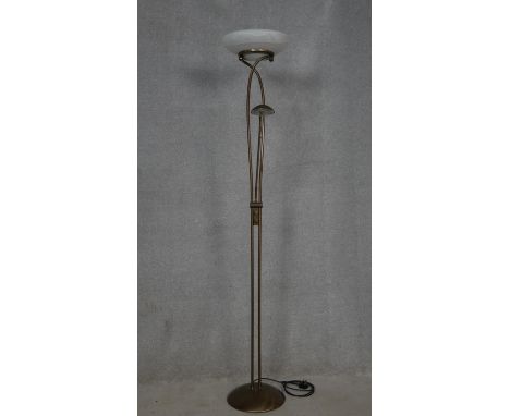 A metal framed uplighter with frosted glass shade and reading lamp extension. H.183cm 