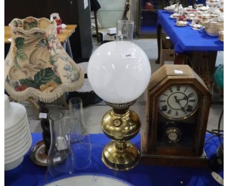 An oil lamp, a barley twist wooden table lamp and a clock Condition Report:Available upon request