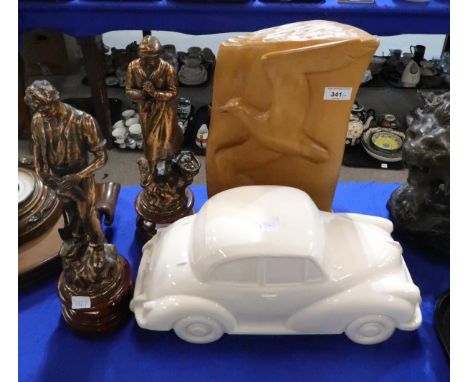 A pair of French spelter figures, a white glazed model of a car and a carved wooden bird sculpture, initialled VT Condition R