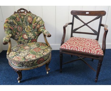 A Victorian mahogany framed floral upholstered easy chair on shaped supports and a Victorian mahogany framed armchair with ta
