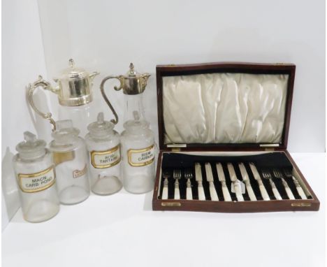 A cased set of mother of pearl handled and EPNS fruit knives and forks, an EPNS lidded moulded glass pitcher with mask spout,