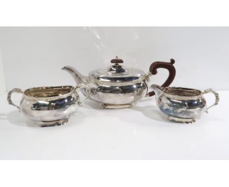 An EPNS bachelors tea service comprising tea pot, sugar bowl and cream jug, with celtic knotwork rims and mythical bird handl