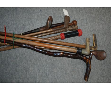 Three vintage golf clubs, seven various walking canes Condition Report:Available upon request