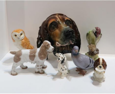 A collection of Beswick animals including a woodpecker, owl, pigeon, dalmatian, spaniel holding 'my plate, another spaniel, a