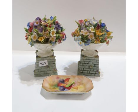 A pair of Royal Worcester urn of flowers ornaments modelled by Mary Leigh, date code for 1938, and a Royal Worcester painted 