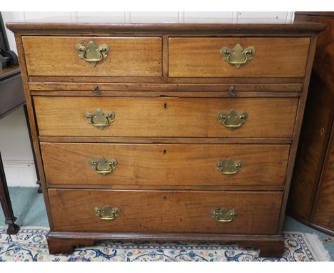 A Georgian mahogany two-over-three chest of drawers, on bracket feet, with pull-out writing surface inset with a green baize 