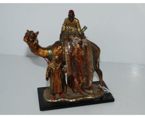 A cold-painted spelter table lighter, modelled as a Arab carpet seller with camel, 22cm high Condition Report:Available upon 