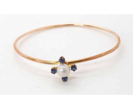 A 9ct gold pearl and sapphire bangle, with original box from Robb Jewellers, Ballater. Weight of the bangle 6gms Condition Re