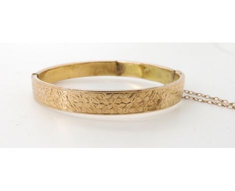 A yellow metal ivy engraved vintage bangle, weight 9.8gms Condition Report:Available upon request