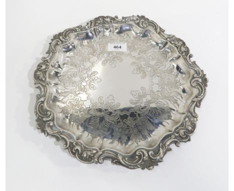 An EPNS salver with engraved scrolling foliage decoration and a chippendale pie crust rim, on ball and claw feet, 32cm Condit
