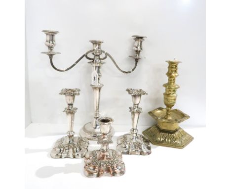 An EPNS three branch candelabra, a pair of EPNS candlesticks, the bases of moulded square form with conical stems, a smaller 