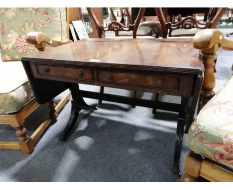 Reproduction mahogany occasional table, sofa table design, two frieze drawers, fluted supports with brass caps and casters, w