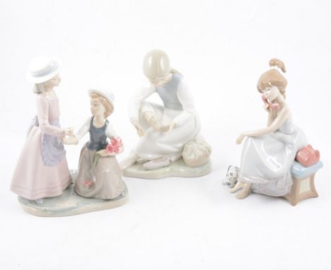 A Lladro figure of a young girl on a telephone and seven other Nao figures of children. (8)