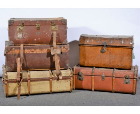 Five large vintage travelling trunks, including tin, stiffened canvas, and wooden bound shells (5)