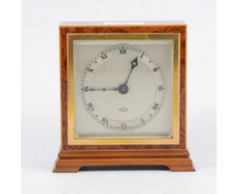 An Elliott mantel clock with square dial and Roman numeral chapter ring in a square birds eye case 14cm high.