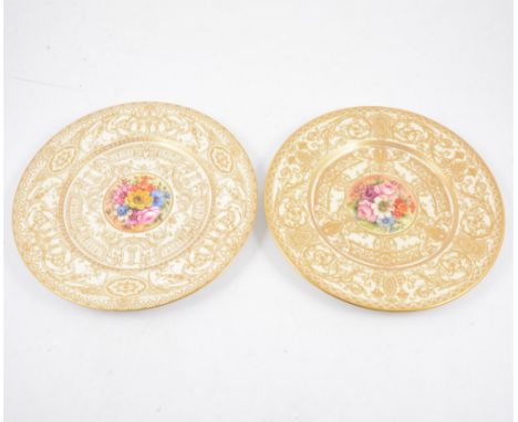 A pair of 20th Century Royal Worcester plates with hand painted floral centre signed by J Freeman. (2)